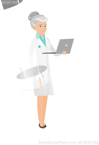 Image of Senior caucasian doctor using a laptop.