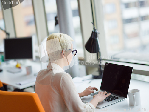 Image of businesswoman using a laptop in startup office