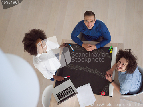 Image of top view of Multiethnic startup business team on meeting