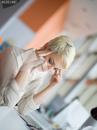 Image of businesswoman using a laptop in startup office