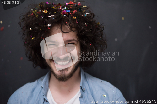 Image of man blowing confetti in the air