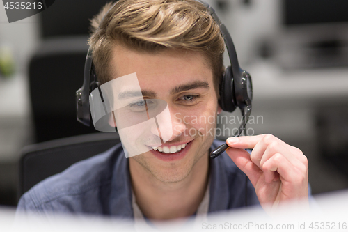 Image of male call centre operator doing his job