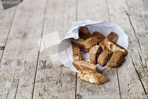 Image of Traditional Italian cookies cantuccini on white paper bag on ruc