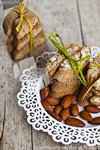 Image of Fresh Italian cookies cantuccini stacked and almond seeds  on wh