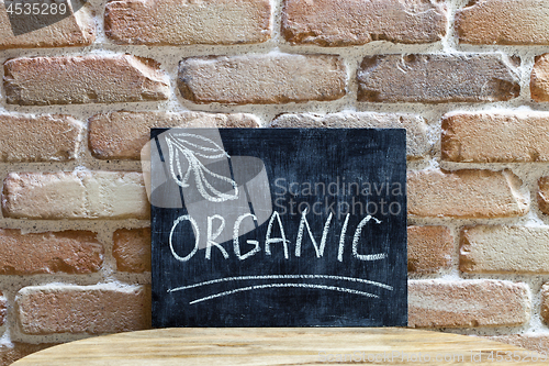 Image of Chalk board with the word ORGANIC drown by hand and chalks on wo