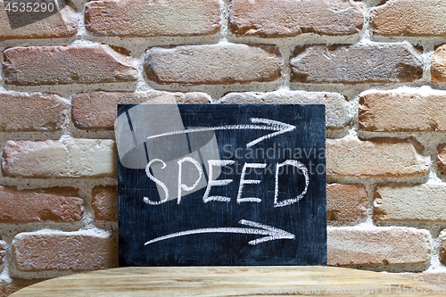 Image of Chalk board with the word SPEED drown by hand and chalks on wood