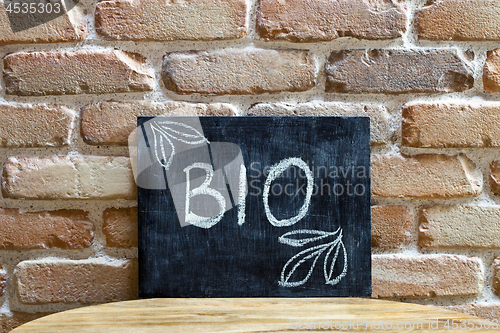 Image of Chalk board with the word BIO drown by hand and chalks on wooden