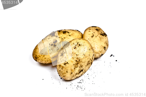 Image of Newly harvested dirty potatoes heap isolated on white background