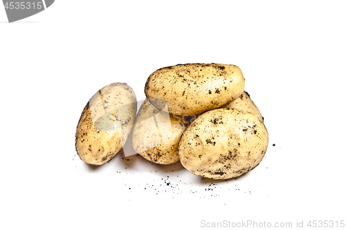 Image of Newly harvested dirty potatoes heap isolated on white background