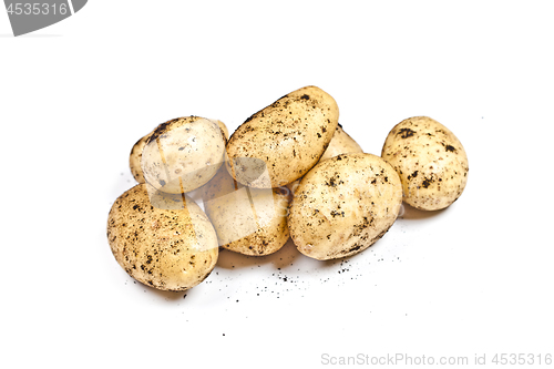 Image of Newly harvested dirty potatoes heap isolated on white background