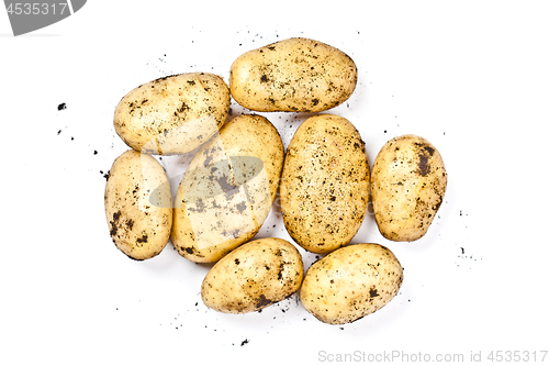 Image of Newly harvested dirty potatoes heap isolated on white background
