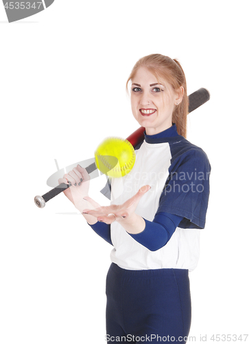 Image of Woman catching the yellow softball