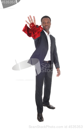 Image of African man throwing his red tie away