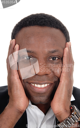 Image of Happy African man with hands on face