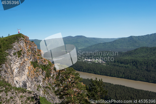 Image of Man standing on top of cliff