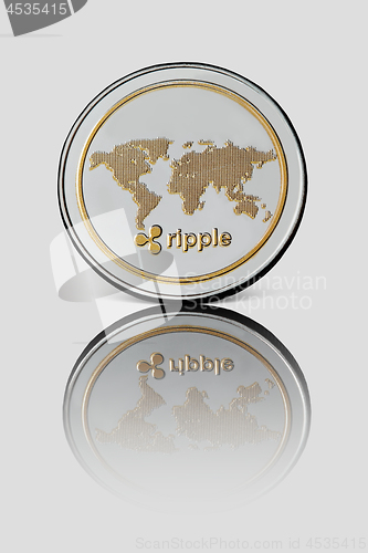 Image of Coin ripple on white glossy background. Business concept