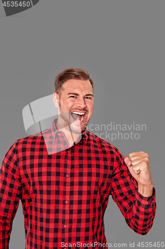 Image of Motivated enthusiastic man cheering 