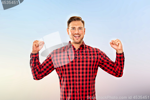 Image of Exultant man cheering a personal success