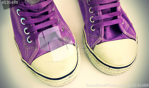 Image of Old lilac sneakers, close-up