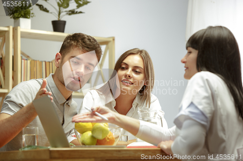 Image of Smiling nutritionist showing a healthy diet plan to patient