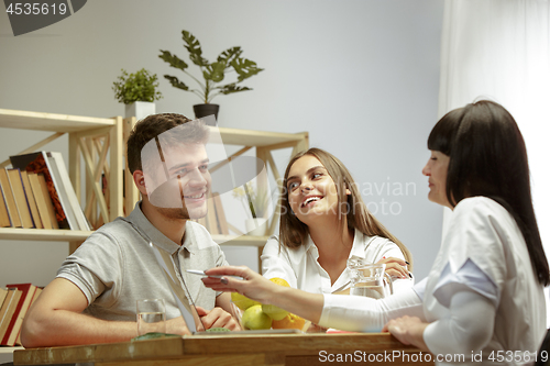 Image of Smiling nutritionist showing a healthy diet plan to patient