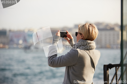 Image of Pretty blonde taking a selfie on a spring day