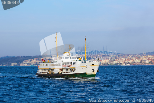 Image of Tourist boat sails on the Golden Horn in Istanbul at sunset, Turkey.