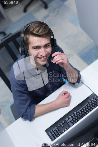 Image of male call centre operator doing his job top view