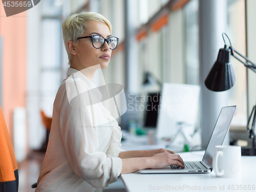 Image of businesswoman using a laptop in startup office