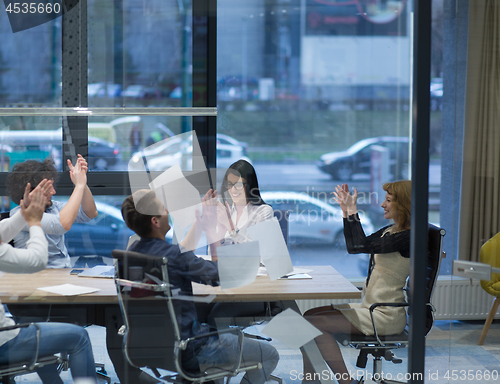 Image of startup Group of young business people throwing documents