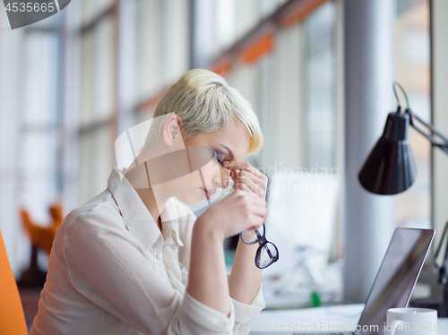 Image of businesswoman using a laptop in startup office