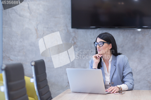 Image of businesswoman using a laptop in startup office