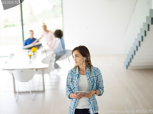 Image of Portrait of  smiling casual businesswoman using tablet  with cow