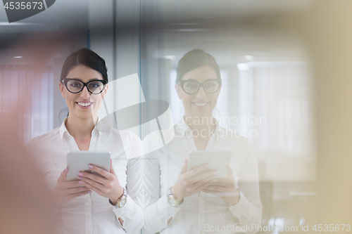 Image of Business Woman Using Digital Tablet in front of startup Office