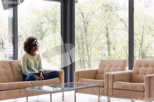 Image of black woman using VR headset glasses of virtual reality