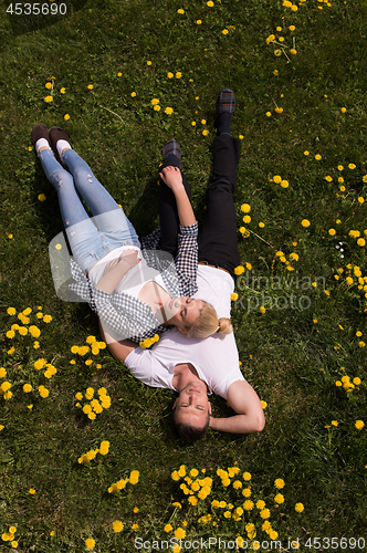 Image of man and woman lying on the grass