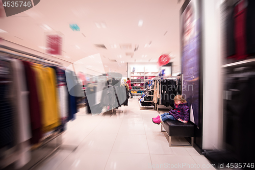 Image of little cute girl in the clothing store