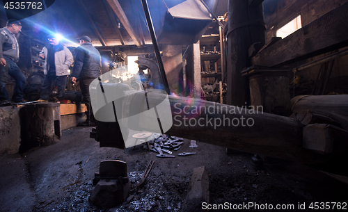 Image of old mechanical hammer at blacksmith traditional workshop