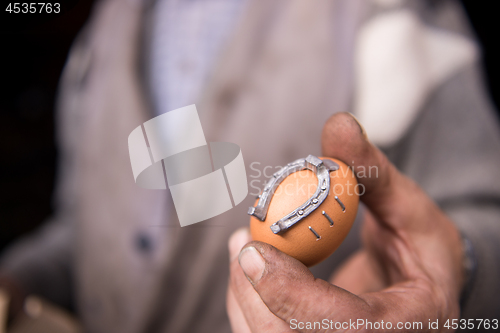 Image of A blacksmith worker showing handmade products ready for sale