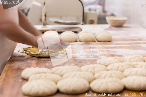 Image of bakery worker preparing the dough