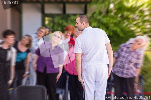 Image of trainer training motivated active healthy senior people