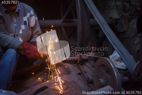 Image of the blacksmith polishing metal products