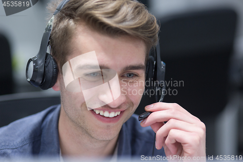 Image of male call centre operator doing his job