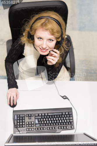 Image of female call centre operator doing her job top view