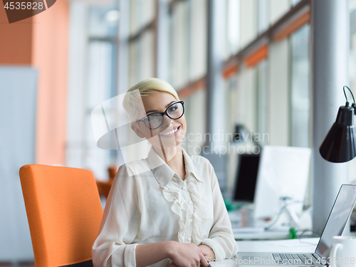 Image of businesswoman using a laptop in startup office