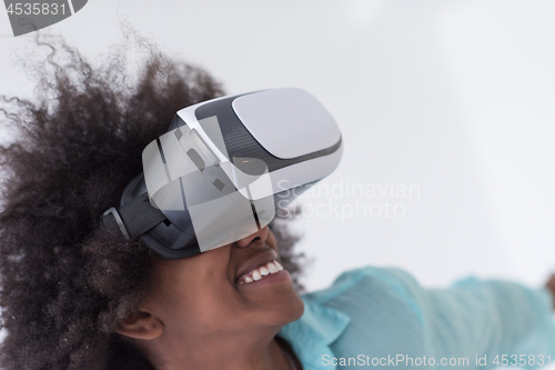 Image of black girl using VR headset glasses of virtual reality