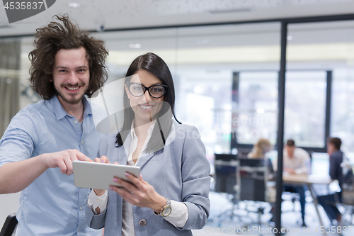 Image of Business People Working With Tablet in startup office