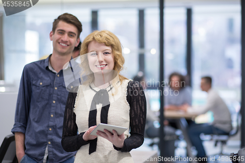 Image of Business People Working With Tablet in startup office