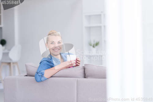 Image of woman enjoying a cup of coffee