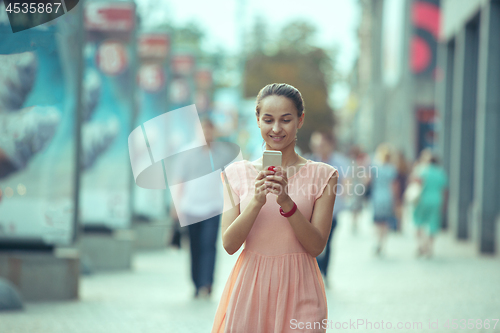 Image of Young Beautiful Woman Talking On Mobile Phone Outdoor.